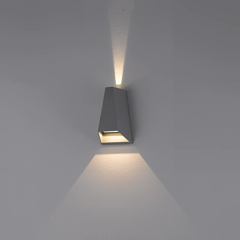 Outdoor pyramid LED wall sconce mounted on a wooden surface, featuring a circular light fixture with distinct shadows and ambient lighting.