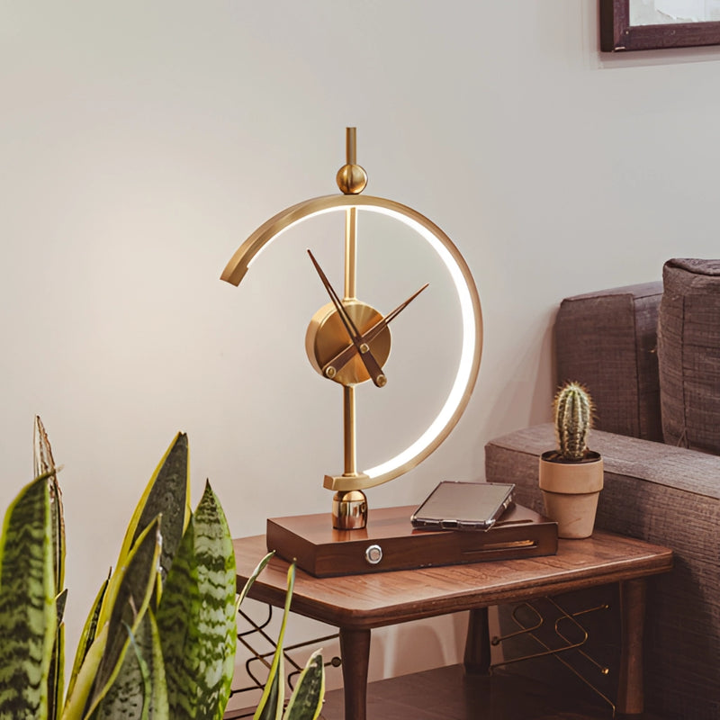 Wireless charging clock lamp with LED light and integrated clock on a wooden table, surrounded by interior design elements including a plant, couch, and picture frame.