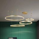Circular LED Pendant Light in Gold Finish with Adjustable Height, featuring four rings in various sizes, dimmable.