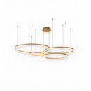 Gold-finished circular LED pendant light with adjustable height, featuring a modern and sleek design.