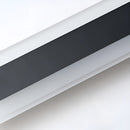 Minimalist LED wall sconce with a sleek vertical rectangular design, made of composite materials and aluminum, emitting soft tints and shades.