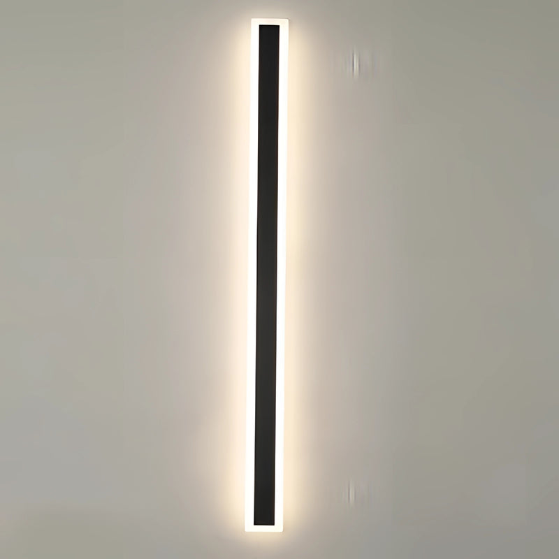Minimalist LED Wall Sconce with a sleek vertical rectangular design, illuminated and mounted on a wall.