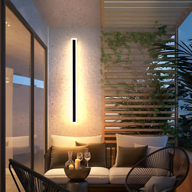 Minimalist LED wall sconce with sleek vertical rectangular design, dimmable 12W light, and motion detector, mounted on a wooden wall in a contemporary interior setting.