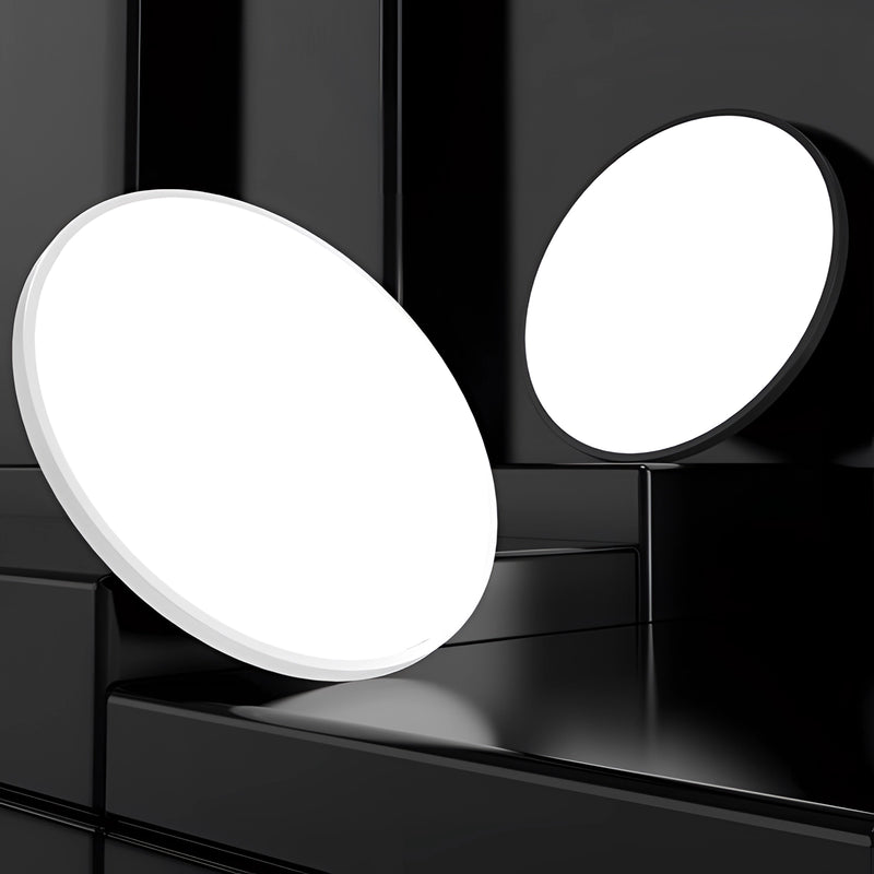 Minimalist round LED ceiling light with a slim, flush mount design, featuring an energy-efficient, monochrome fixture.