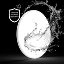 Minimalist round LED ceiling light with a slim, flush mount design, emitting a soft glow in a dark room.