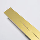 Minimalist slim gold bar pendant necklace with a modern vertical design, displayed on a wooden surface.
