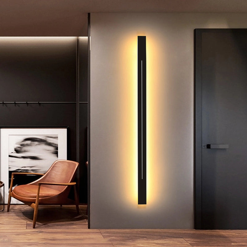 Minimalist slim gold bar pendant necklace on a modern vertical chain displayed on a wooden surface.