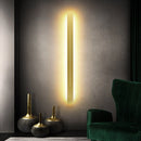 Minimalist Slim Gold Bar Pendant Necklace with Modern Vertical Design, shown in a well-lit interior setting.