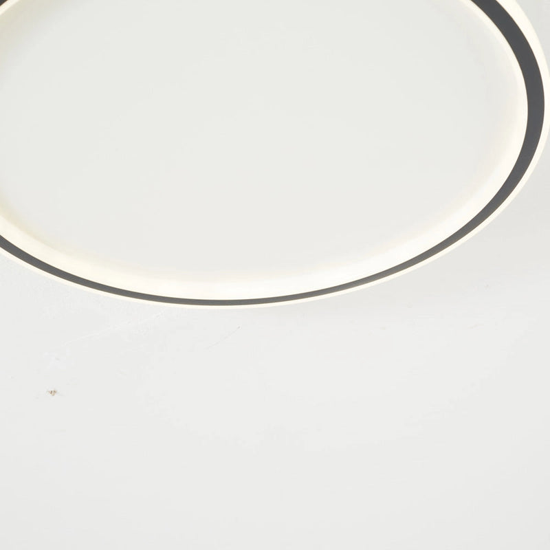 Modern LED Ceiling Light with minimalist circular design, mounted flush to the ceiling, energy efficient with metal accents.