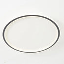 Modern LED ceiling light with minimalist circular design, flush mount, energy efficient, metal finish, installed on the ceiling.