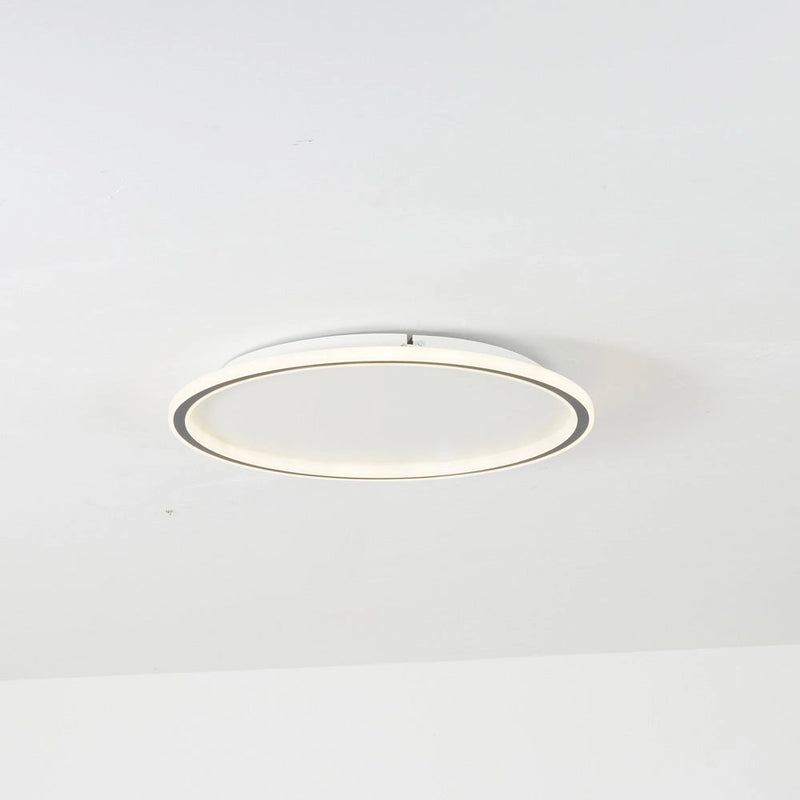 Modern minimalist circular LED ceiling light flush mount with metal trim, energy-efficient design.