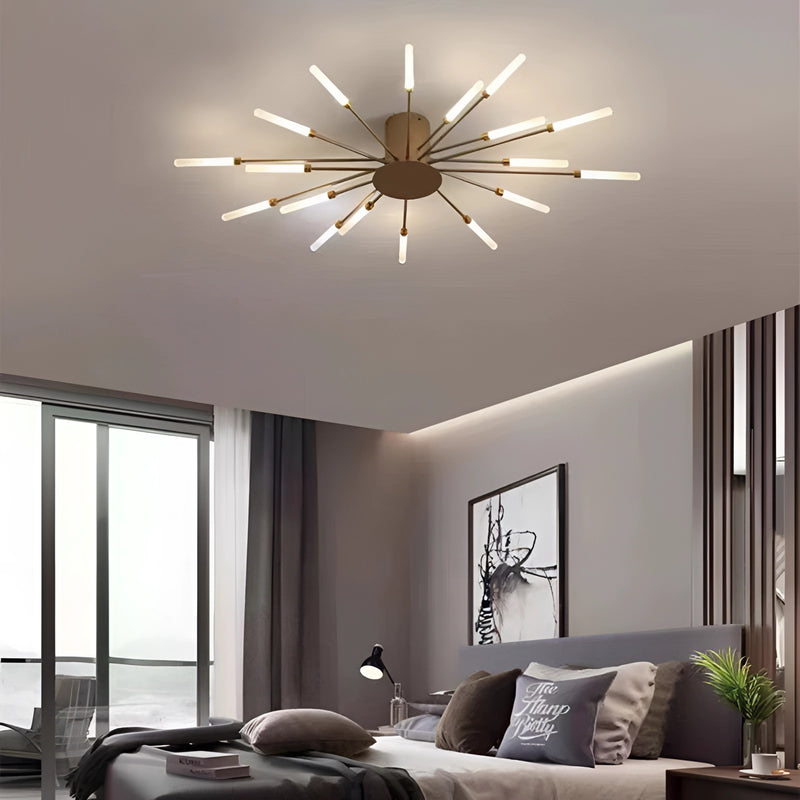 A mid-century modern starburst wall art sculpture in black and gold metal, featuring a dimmable 18W golden diffuser, mounted on a wall inside a well-furnished room with contemporary interior design elements including furniture, lighting, and a window.