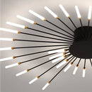 Modern starburst wall art in black and gold metal, featuring a mid-century design with circular and starburst patterns.