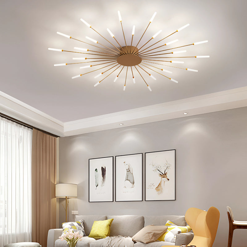 Modern starburst wall art in black and gold metal hanging above a comfortable couch in a stylish mid-century living room with warm lighting and wooden furniture elements.
