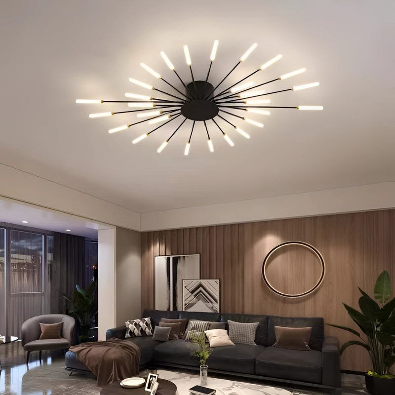 Modern starburst wall art in black and gold metal sculpture, displayed above a comfortable couch with houseplants and flowerpots enhancing the mid-century interior design.