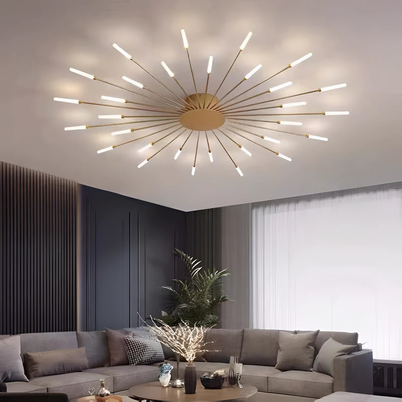 Mid-century modern starburst wall art made of black and gold metal, displayed above a couch in a stylish living room with contemporary furniture and lighting.