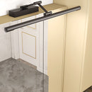 Sleek black dimmable LED picture light mounted on a wooden wall above a shelf.