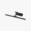 Sleek black dimmable LED picture light, cordless and adjustable, wall-mounted above a wooden rectangular frame.