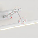 Sleek black dimmable LED picture light, cordless and adjustable, wall-mounted above framed artwork.