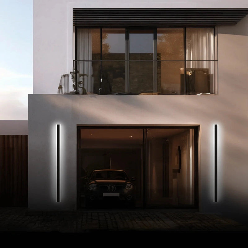 Slim Vertical LED Wall Sconce mounted on exterior wall of modern building near a car.