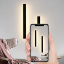 Slim Vertical LED Wall Sconce mounted on a wood-paneled wall, minimalist design, waterproof, modern rectangular shape.