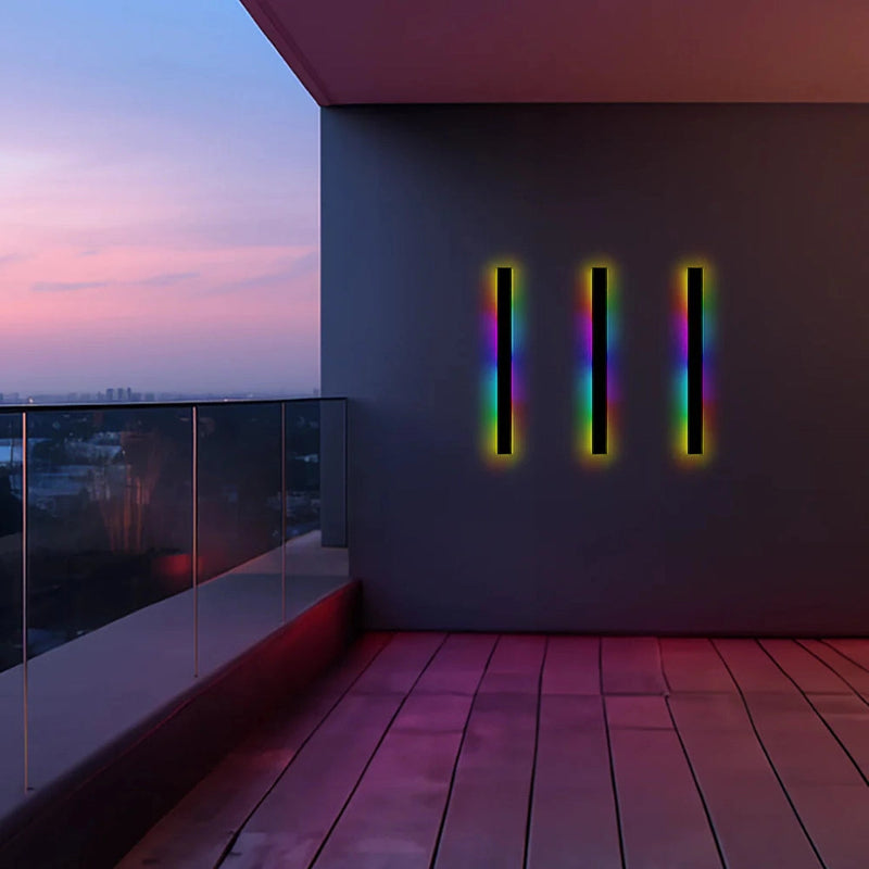 Slim Vertical LED Wall Sconce mounted on a wooden wall, emitting RGB light with motion sensors, in a minimalist and stylish interior setting.